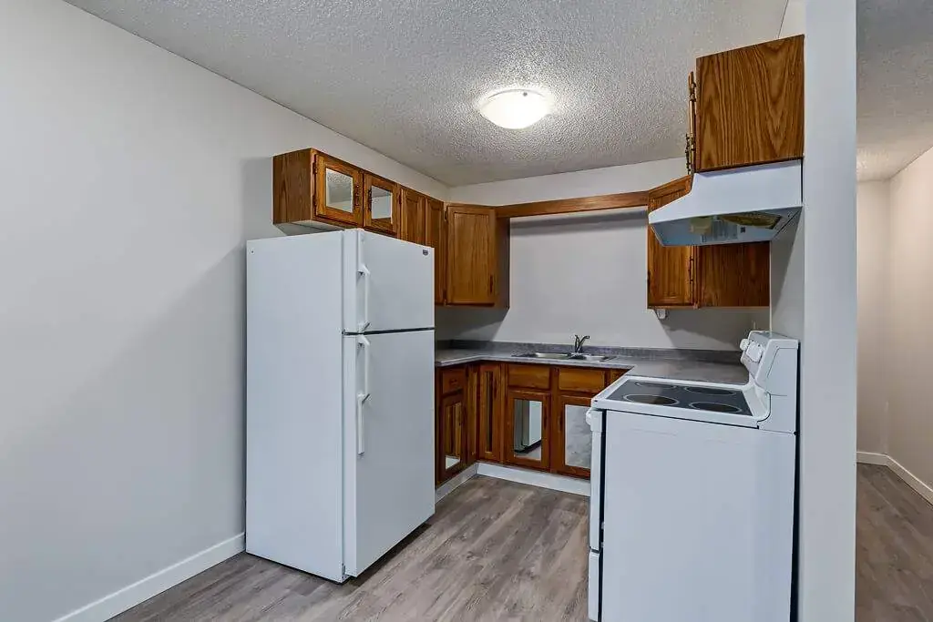 Compact and well-equipped kitchen at Concord Apartments in Regina.