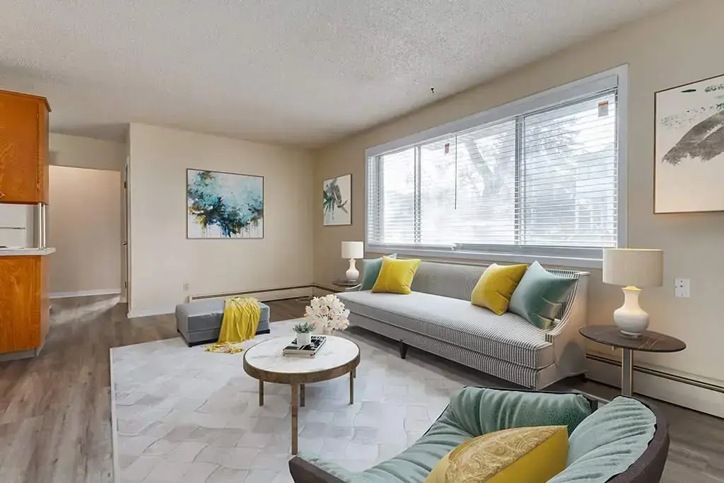 Bright living room with large windows at Laney Lodge in Regina.