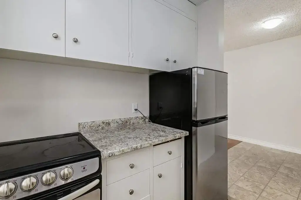 Contemporary kitchen with stainless steel appliances at Berkeley Manor in Saskatoon.