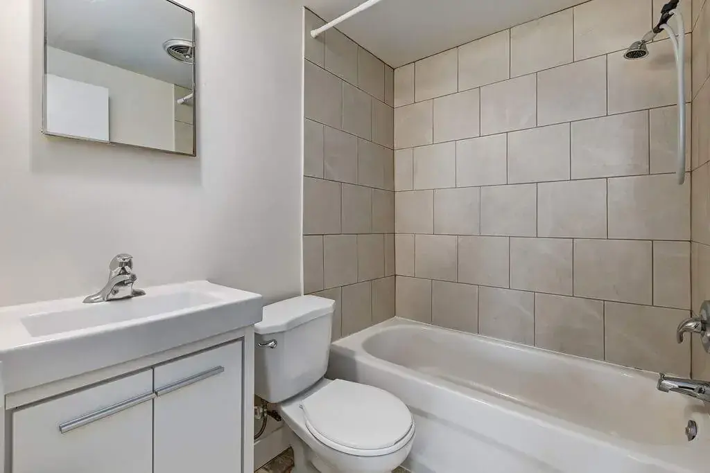 Functional full bathroom with tub and shower at Berkeley Manor in Saskatoon.