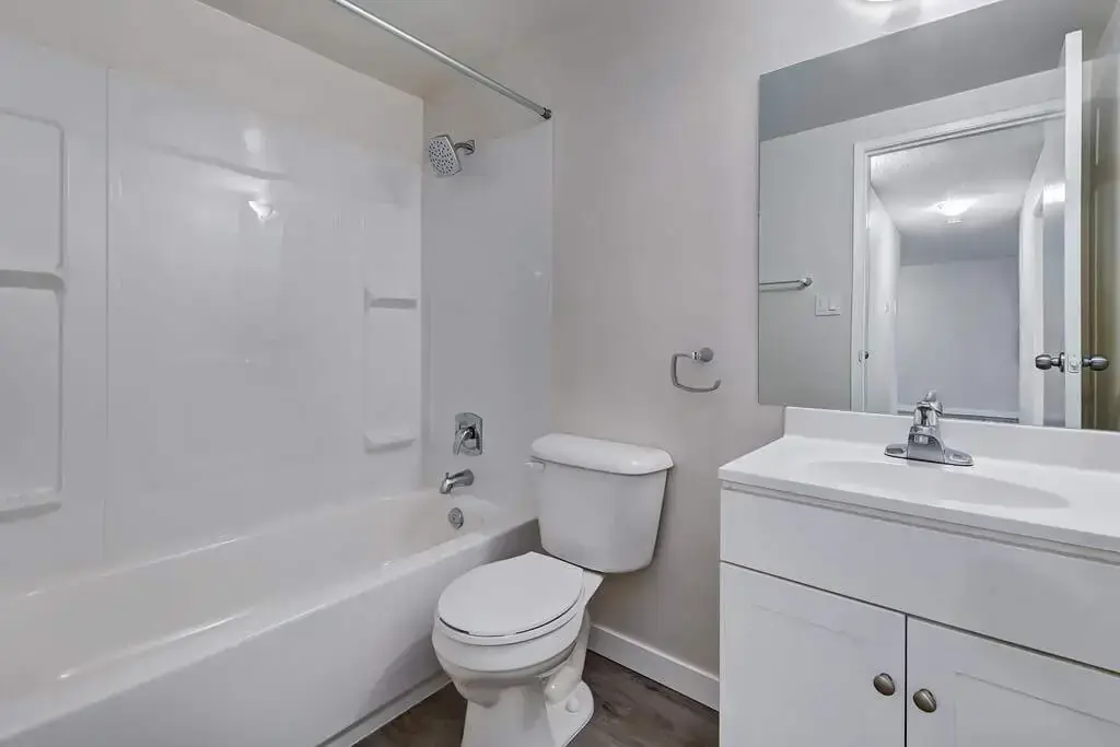 Functional full bathroom with tub and shower at Caswell Manor in Saskatoon.
