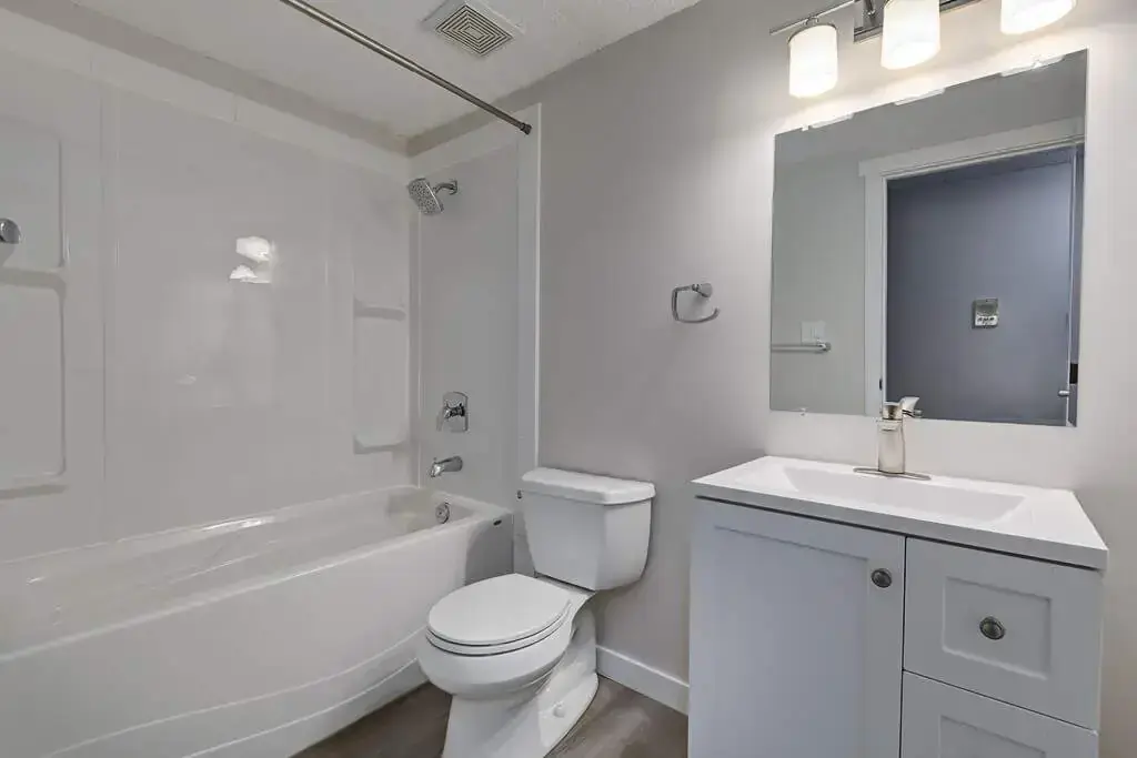 Full bathroom with bathtub and shower combination at Caswell Manor in Saskatoon.