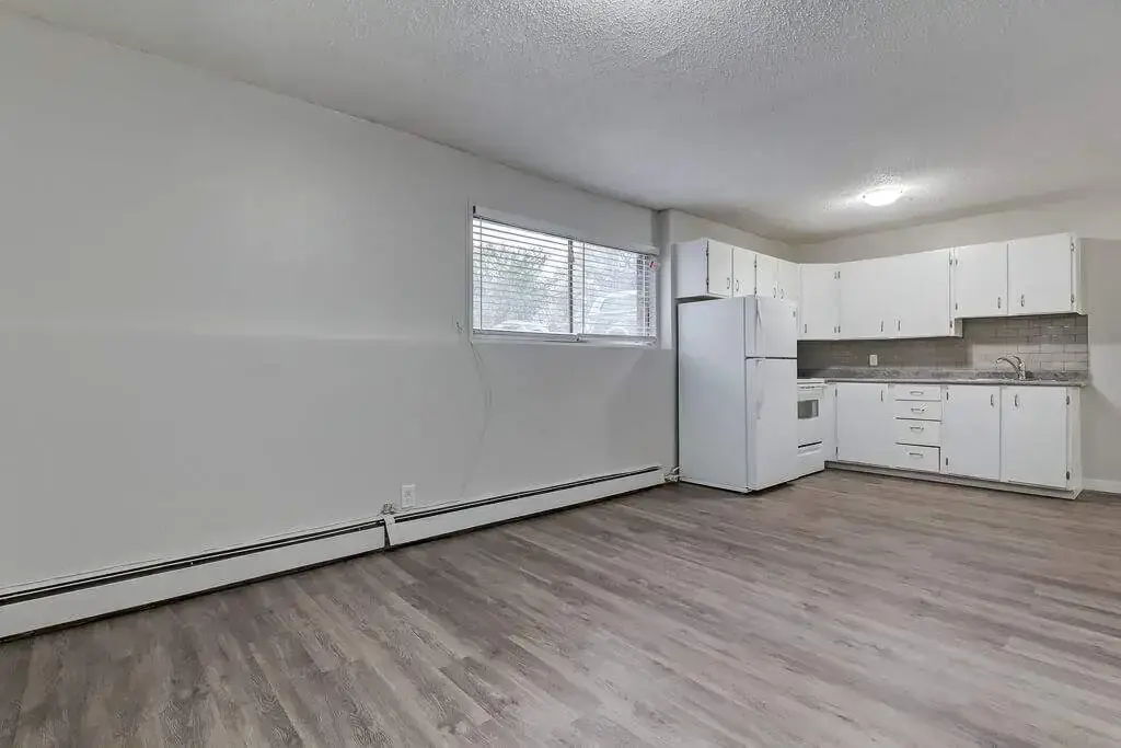 Open kitchen design connected to living space at Caswell Manor in Saskatoon.