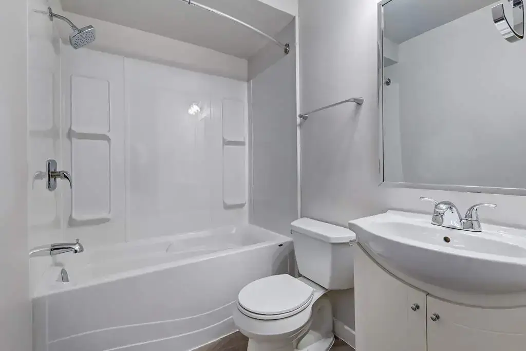 Apartment bathroom with tub and shower at Caswell Manor in Saskatoon.