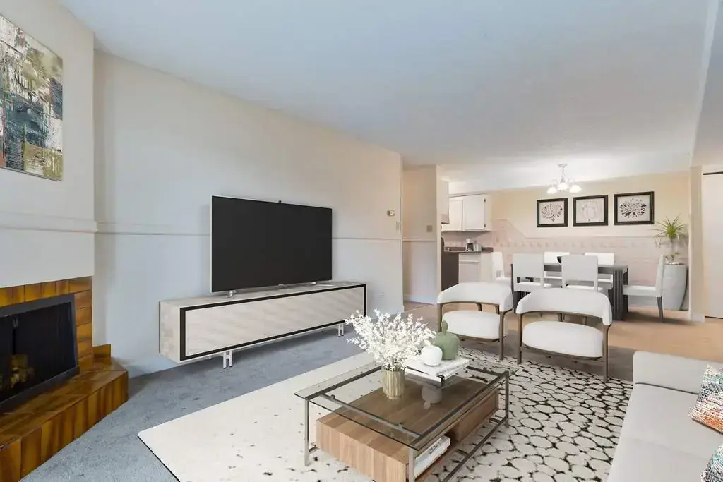 Bright and open living room with large windows at Chancellor Gate in Saskatoon.