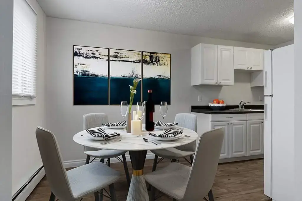 Galley style kitchen and dining area with natural light at Erica Louise Manor in Saskatoon.