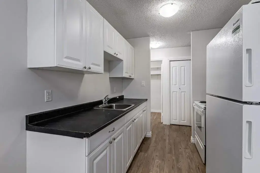 Galley style kitchen with appliances at Erica Louise Manor in Saskatoon.