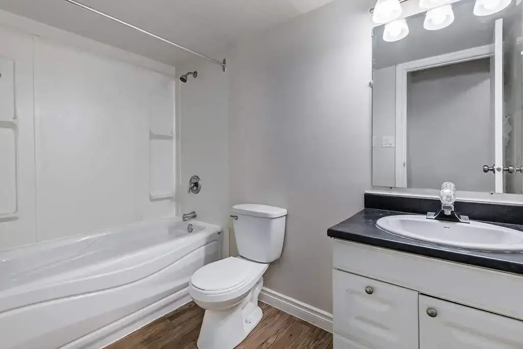Comfortable full bathroom with tub and shower at Erica Louise Manor in Saskatoon.