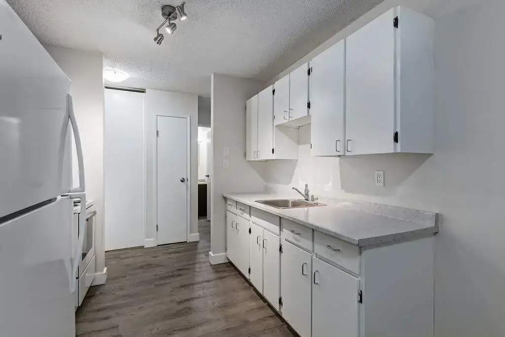 Functional kitchen with appliances at Erica Louise Manor in Saskatoon.