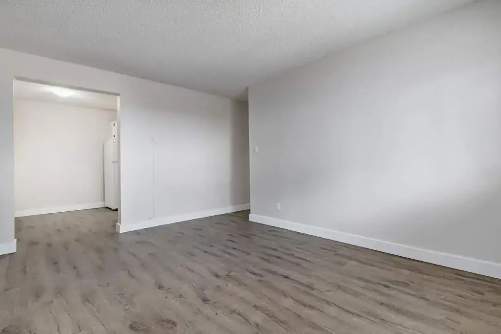 Inviting living room space and dining area at Erica Louise Manor in Saskatoon.