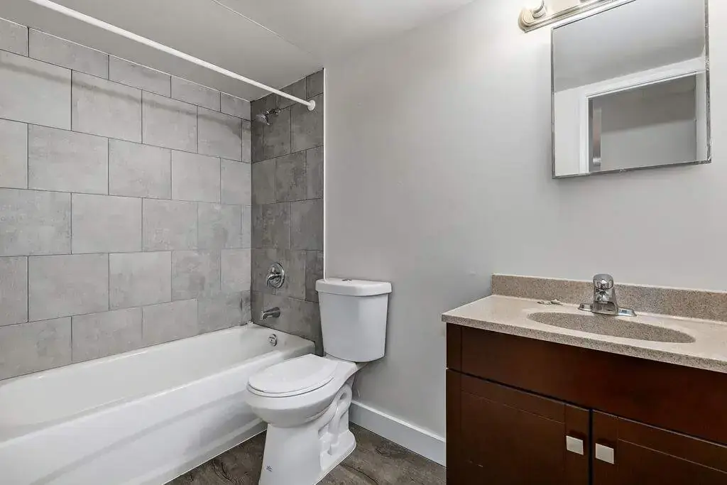 Comfortable full bathroom with tub and shower at Erica Louise Manor in Saskatoon.