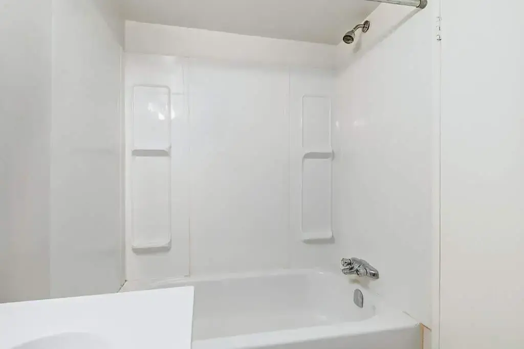 Comfortable full bathroom with tub and shower at Miami Apartments in Saskatoon.