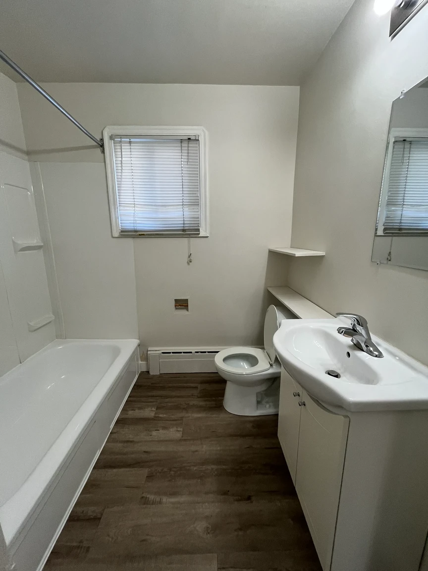 Spacious full bathroom featuring a tub and shower at Skyview Apartments in Edmonton.