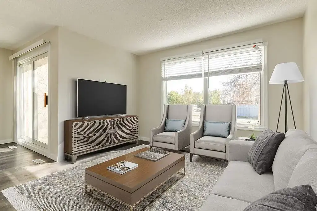 Bright living room with large windows at Country View Estates in Wetaskiwin.