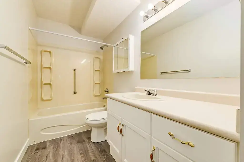 Apartment bathroom with tub and shower at Crowchild Court in Wetaskiwin.