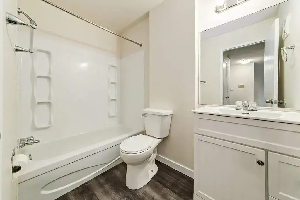 Bright full bathroom with tub and shower at Westwind Apartments in Wetaskiwin.