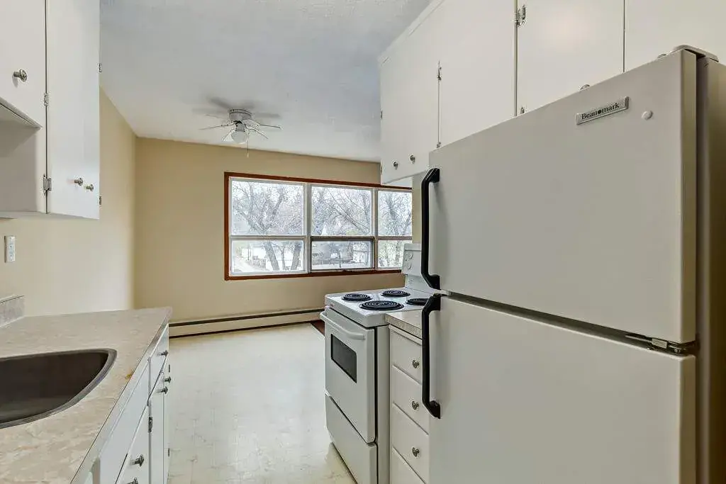 Galley style kitchen with appliances at Crescent Court in Yorkton.