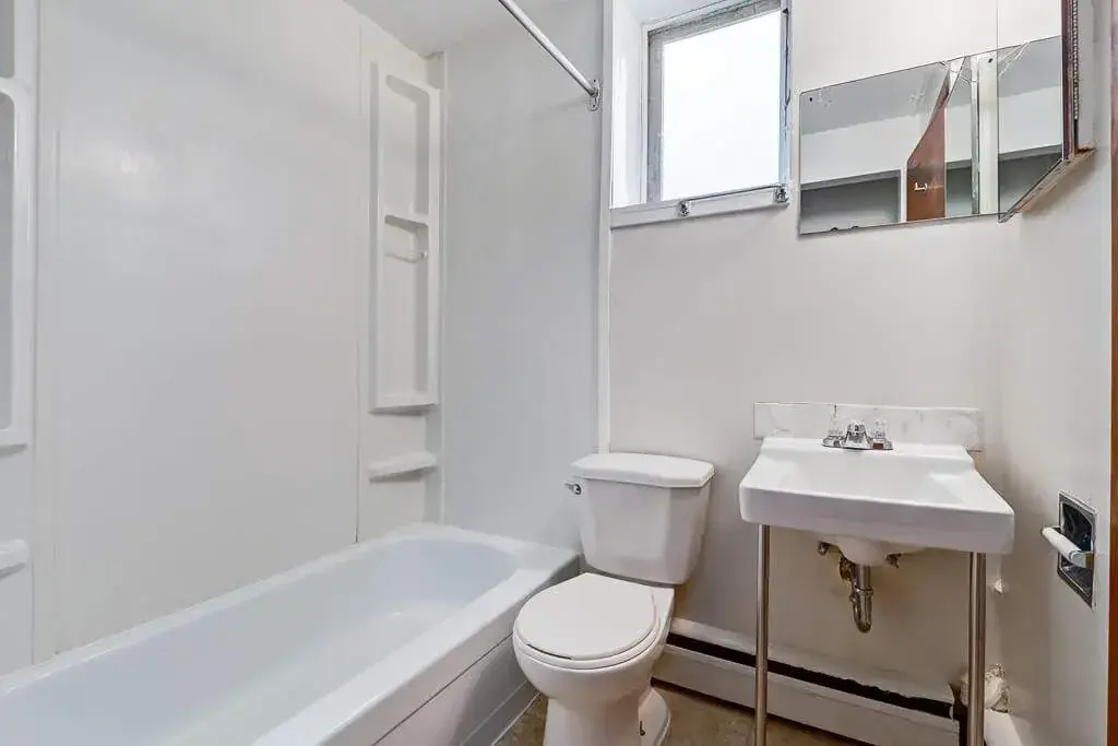 Clean full bathroom with tub and shower at Crescent Court in Yorkton.