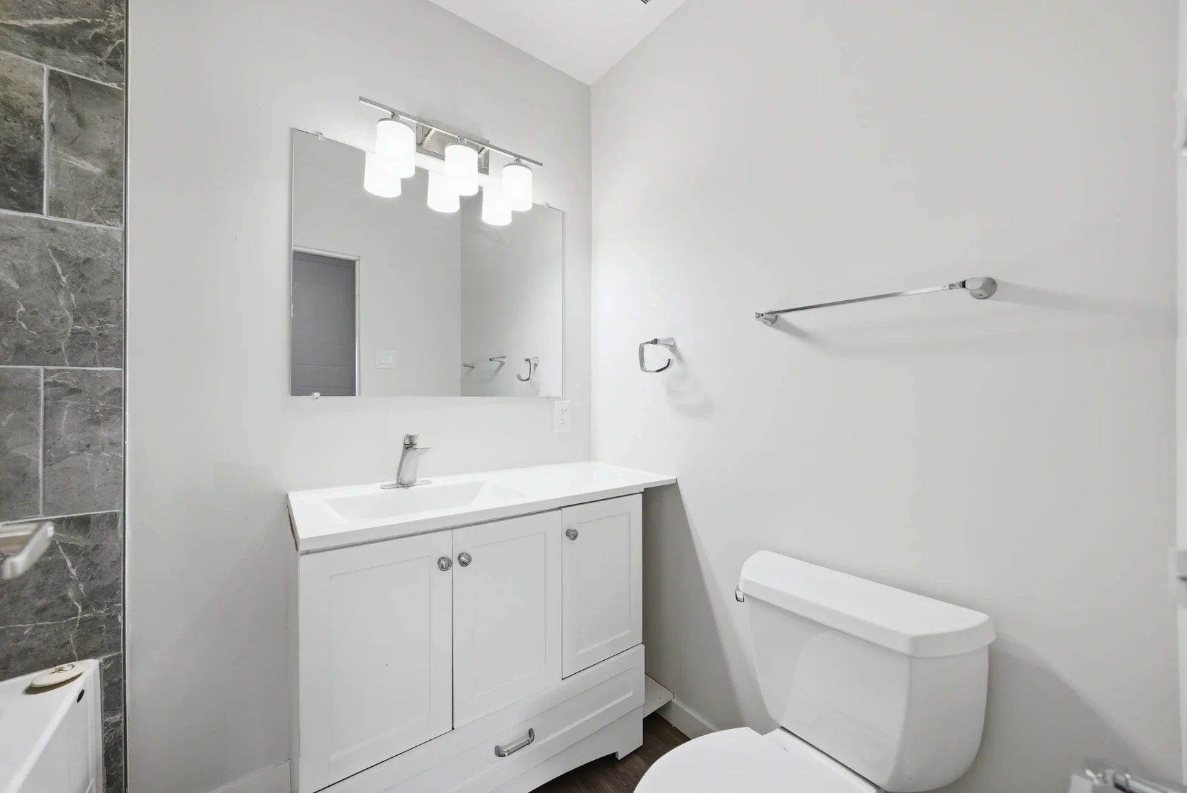 Apartment bathroom with tub and shower at Miami Apartments in Saskatoon.
