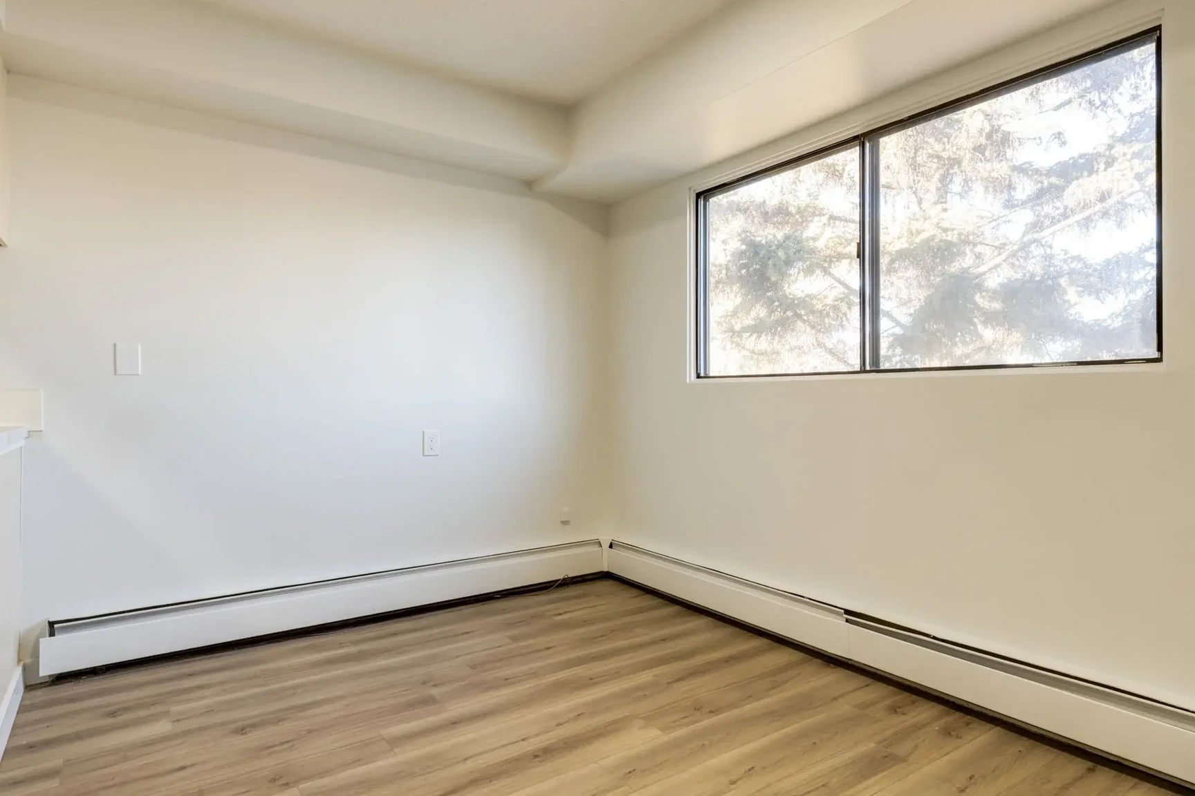 Bright bedroom with comfortable proportions at South Ridge Apartments in Edmonton.