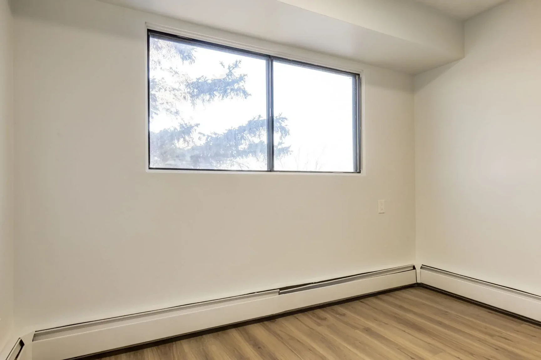 Open bedroom space with flexible layout at South Ridge Apartments in Edmonton.