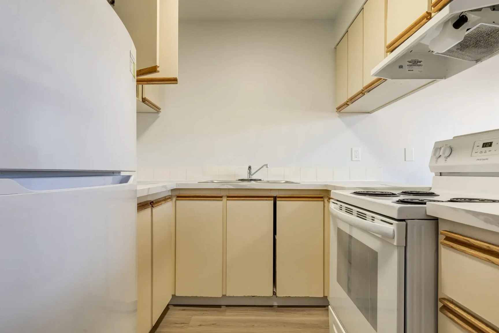 Functional kitchen with appliances at South Ridge Apartments in Edmonton.