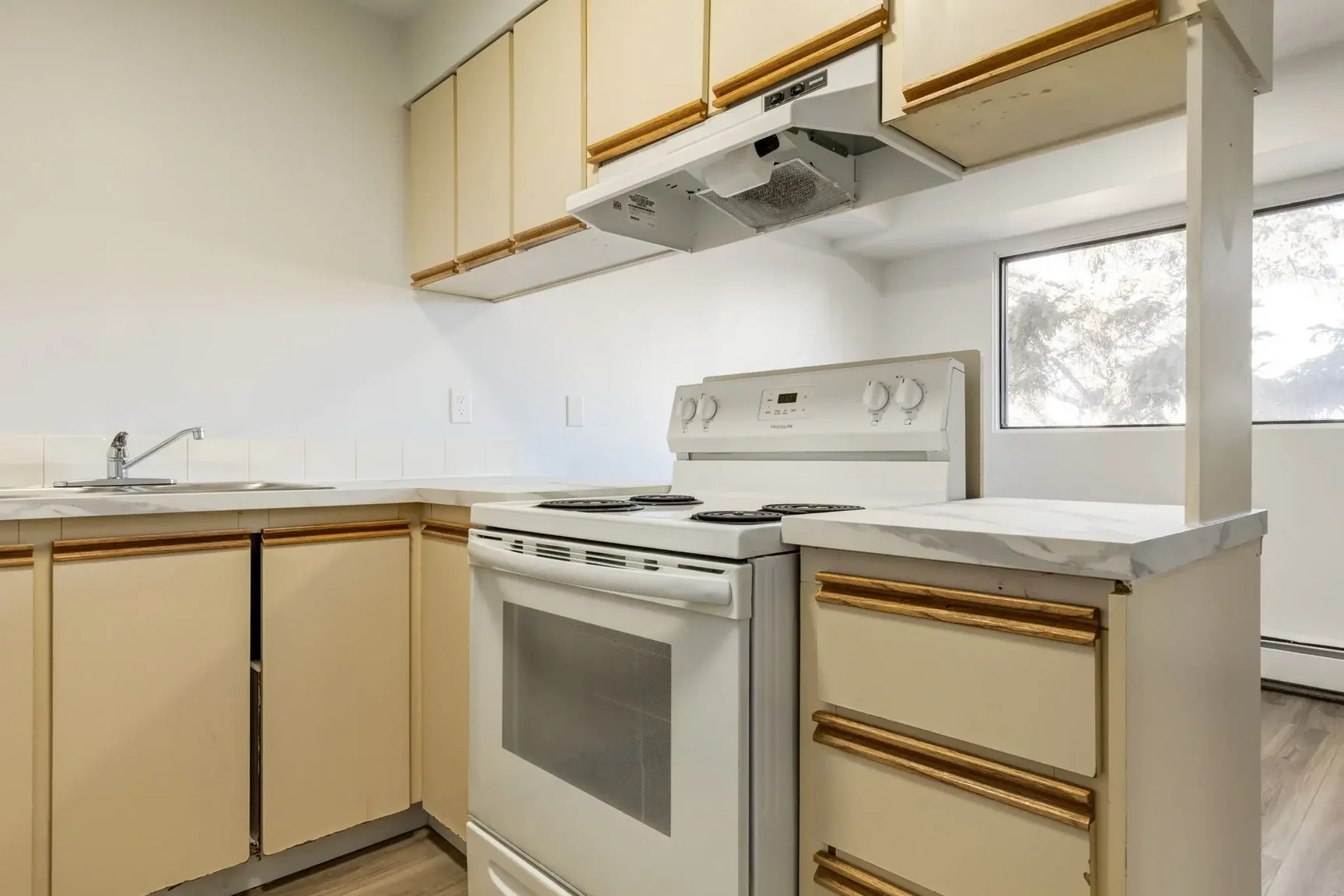 Functional kitchen with appliances at South Ridge Apartments in Edmonton.