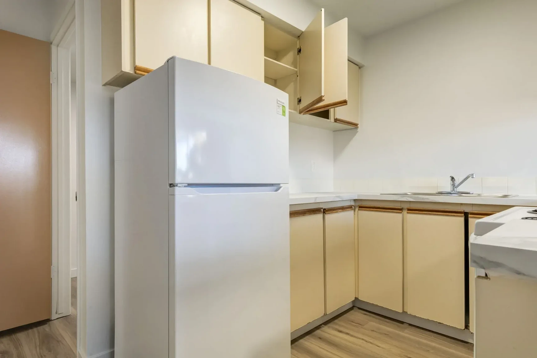 Functional kitchen with appliances at South Ridge Apartments in Edmonton.