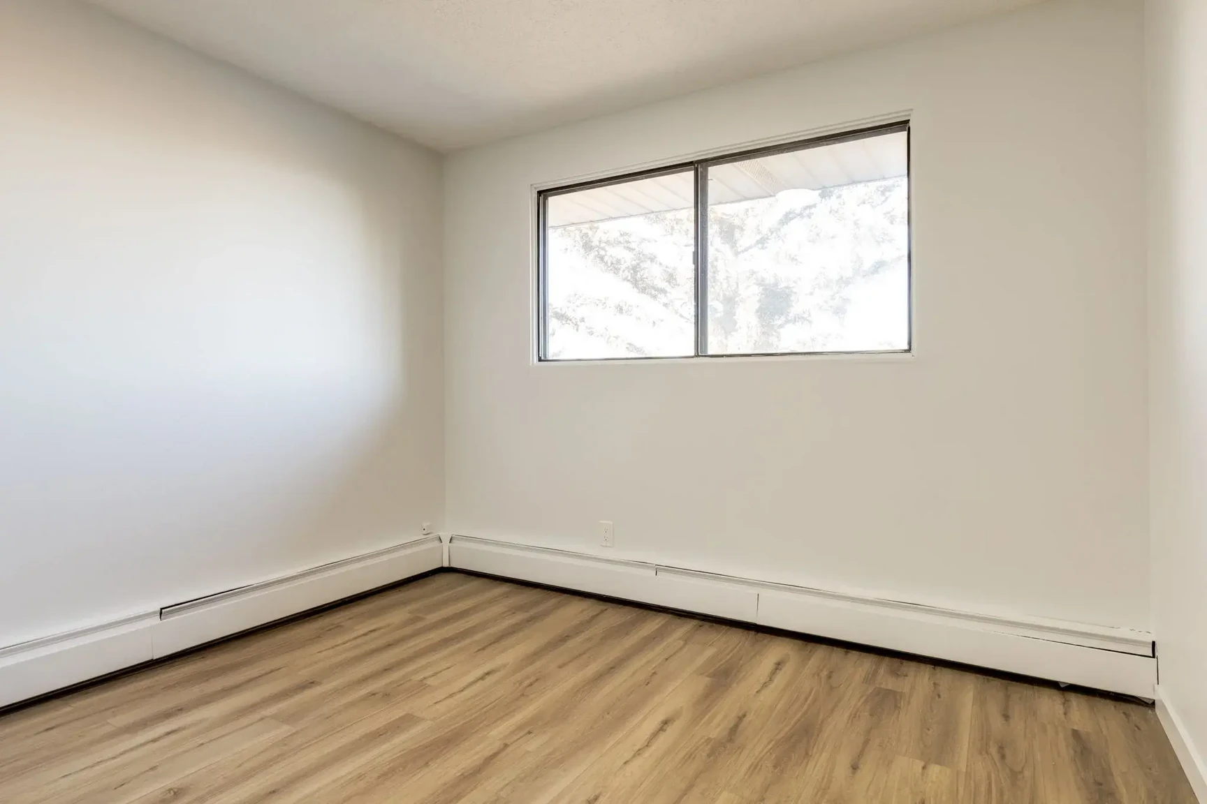 Comfortable and well-sized bedroom at South Ridge Apartments in Edmonton.