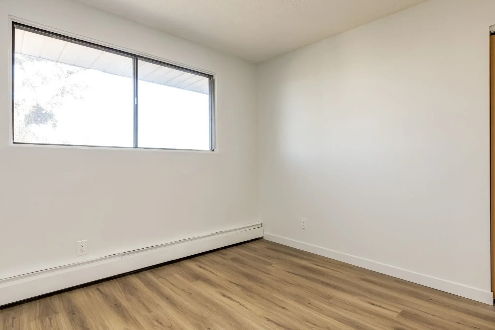Open bedroom space with flexible layout at South Ridge Apartments in Edmonton.