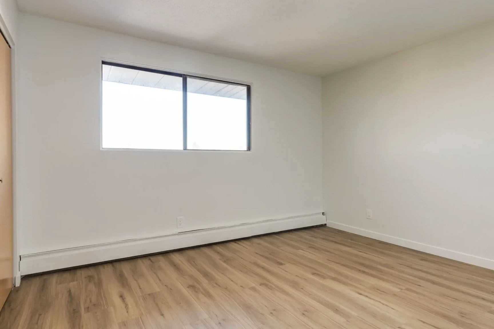 Comfortable and well-sized bedroom at South Ridge Apartments in Edmonton.