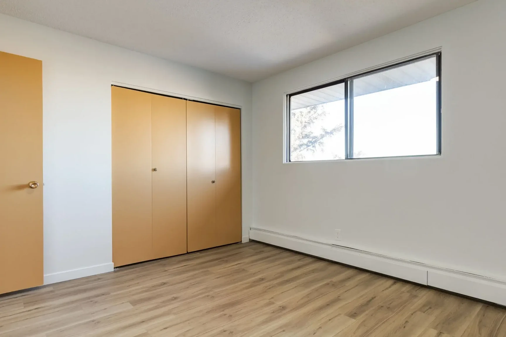 Open bedroom space with flexible layout at South Ridge Apartments in Edmonton.