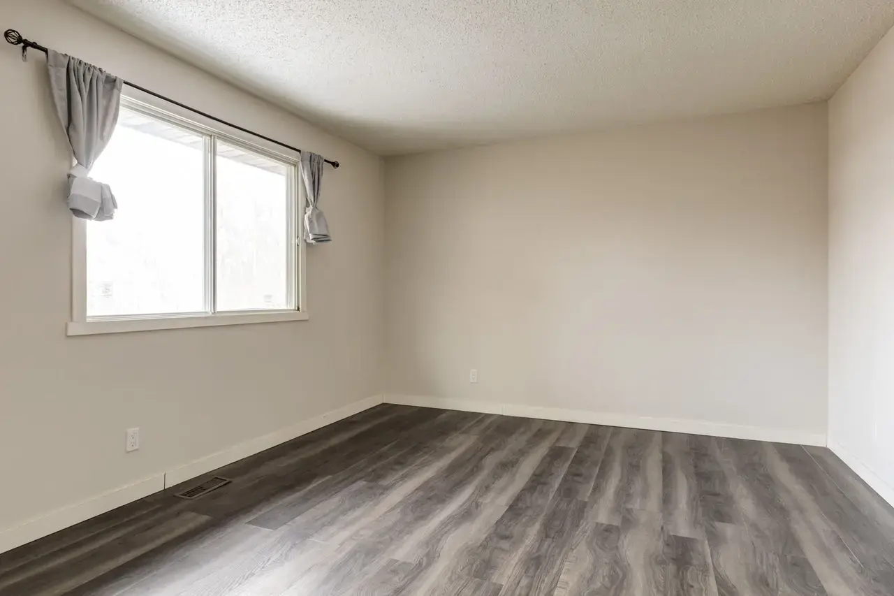 Bright bedroom with comfortable proportions at Spruce View Apartments in Camrose.