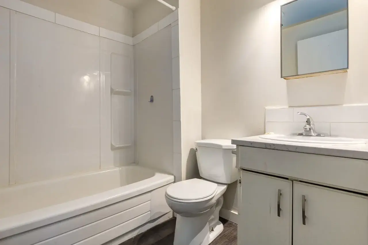 Bright full bathroom with tub and shower at Spruce View Apartments in Camrose.