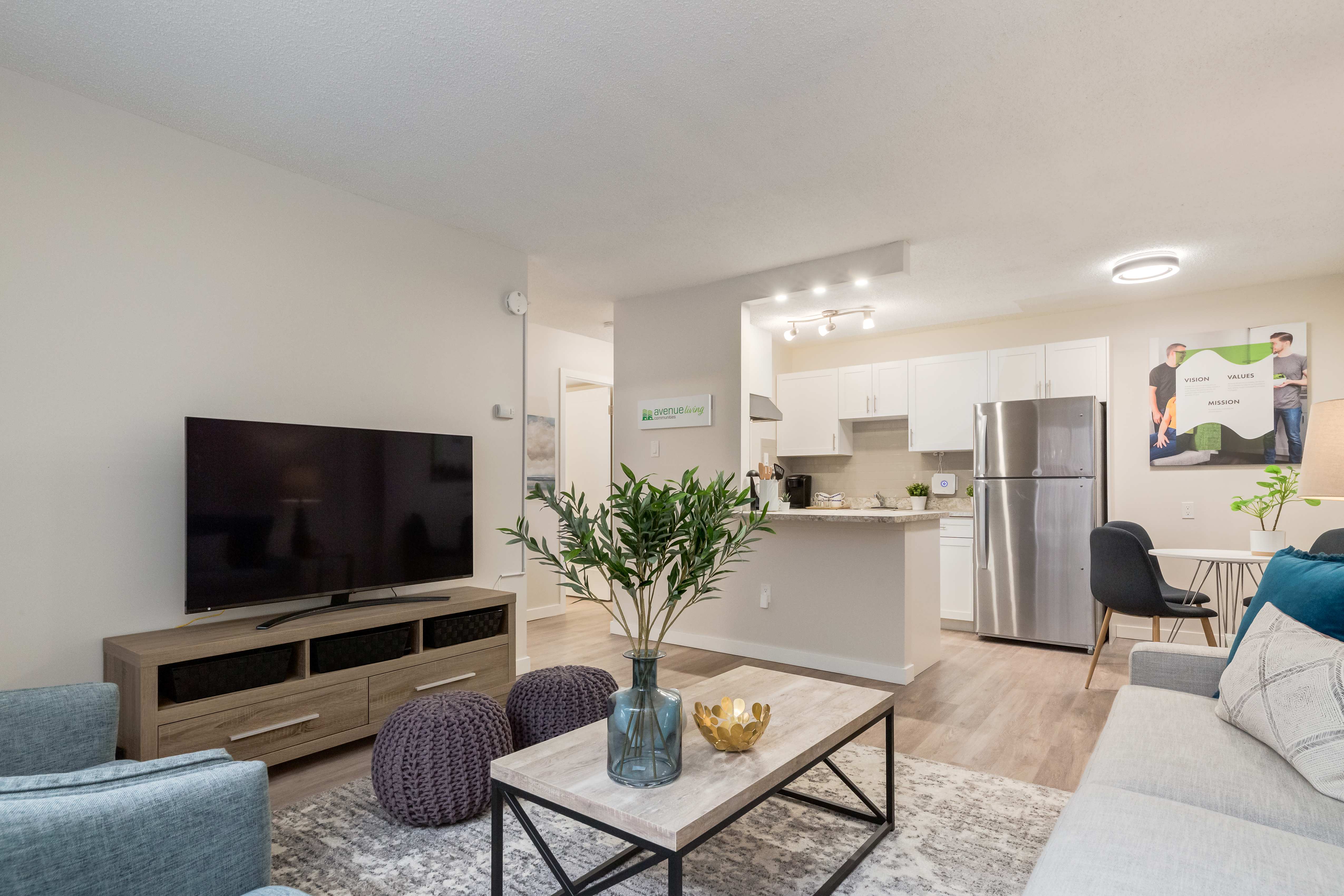 Image of living room and kitchen inside an apartment.
