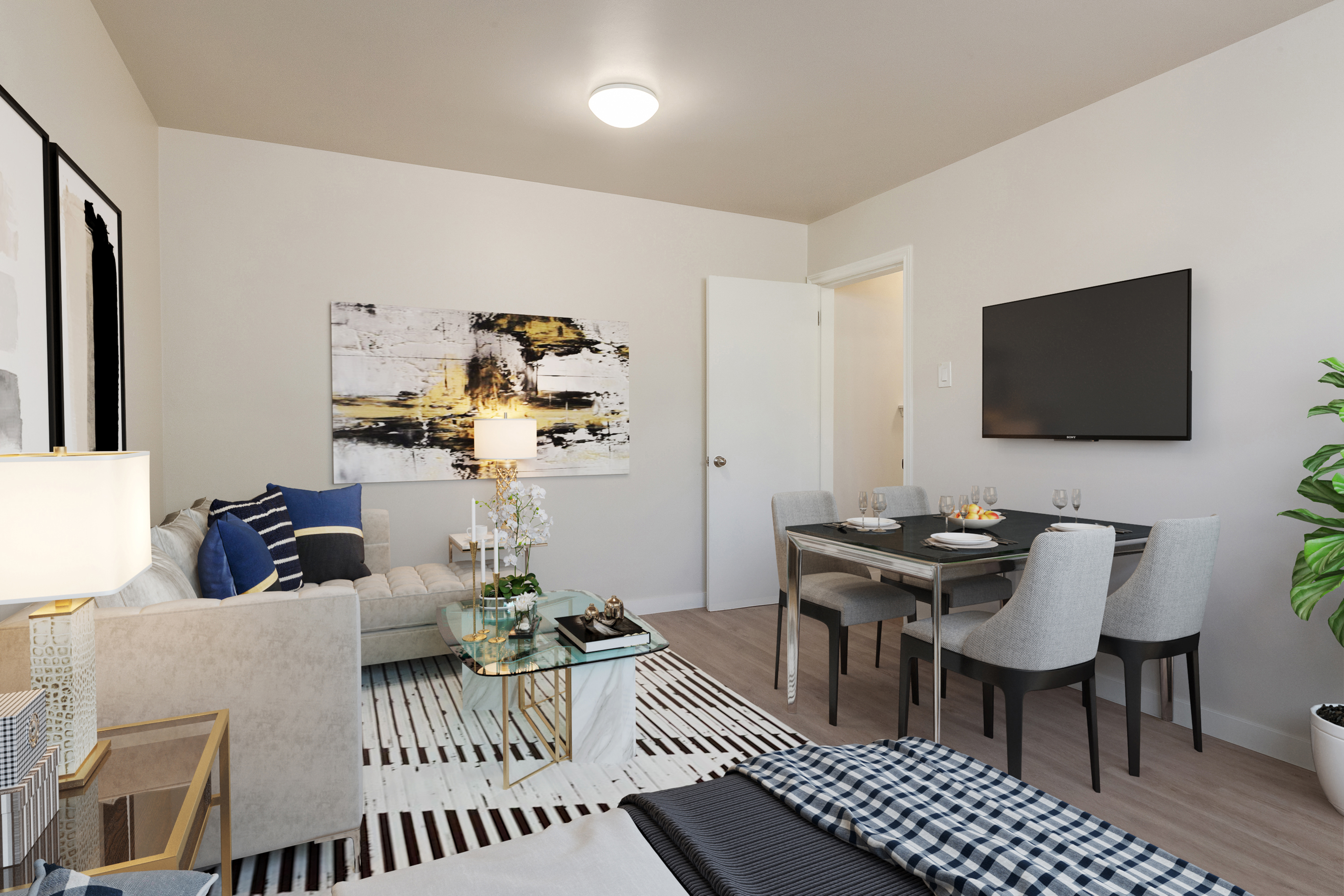 Image of couch and dining table inside Simon’s Court in Edmonton.