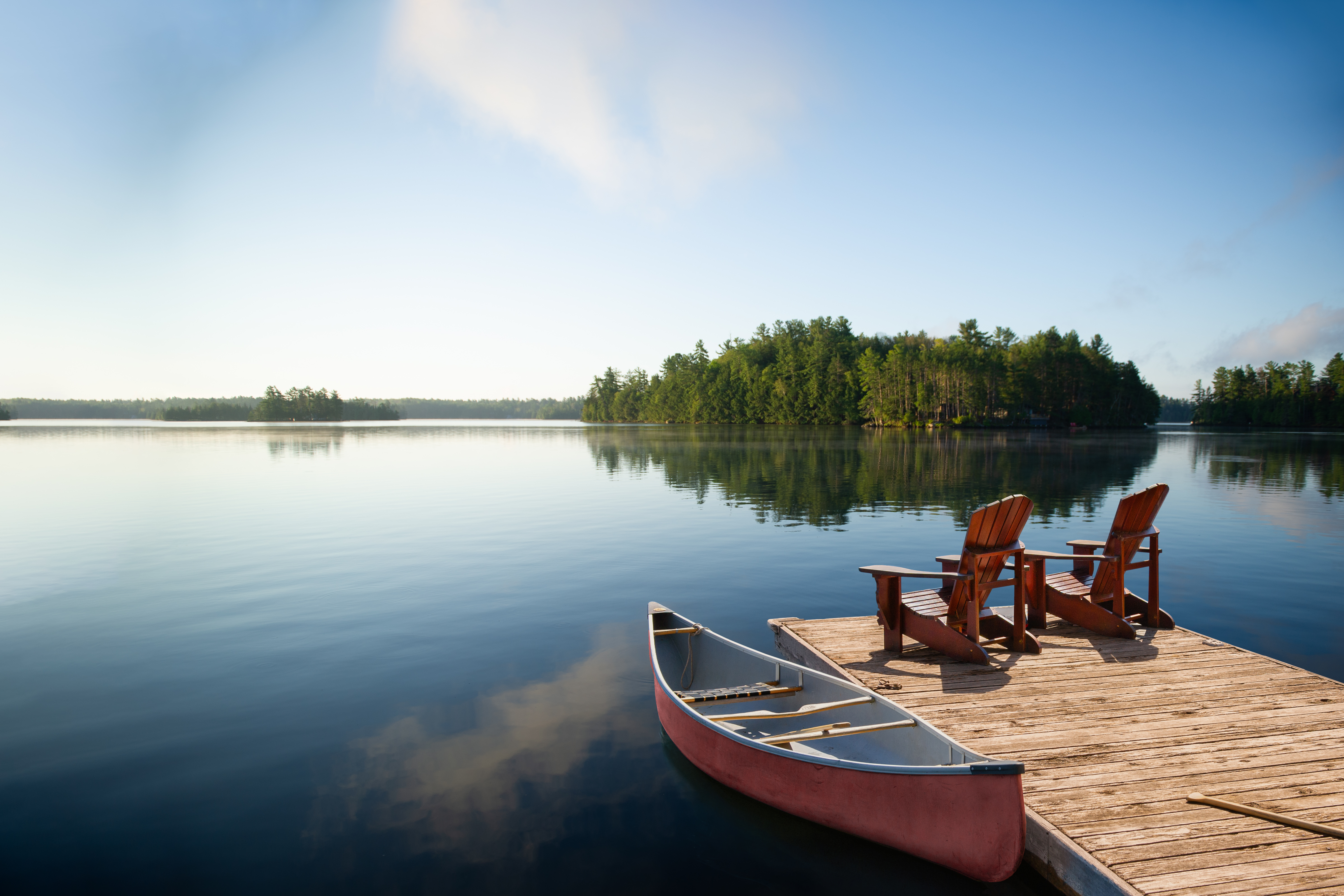 Image of canoes by a lake.