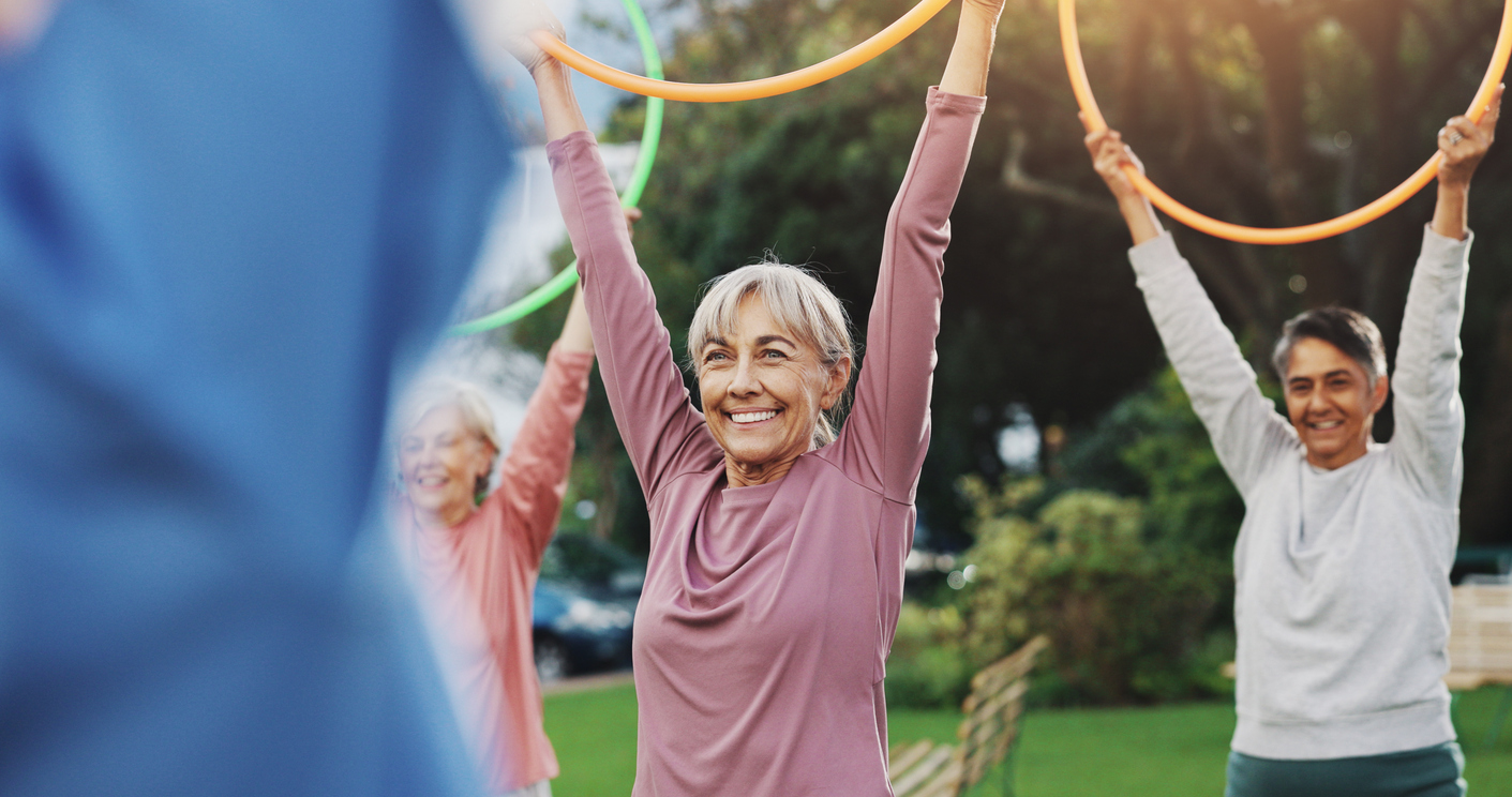 Image of seniors doing an activity in an outdoor green space.
