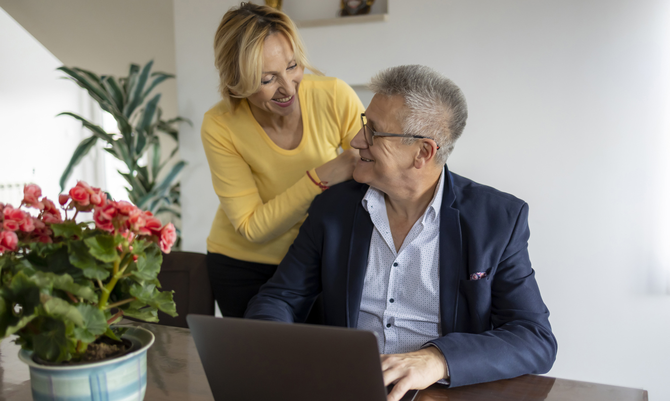 Image of senior couple smiling at each other.
