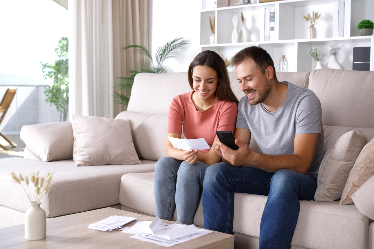 Couple reviewing real estate documents with an agent.