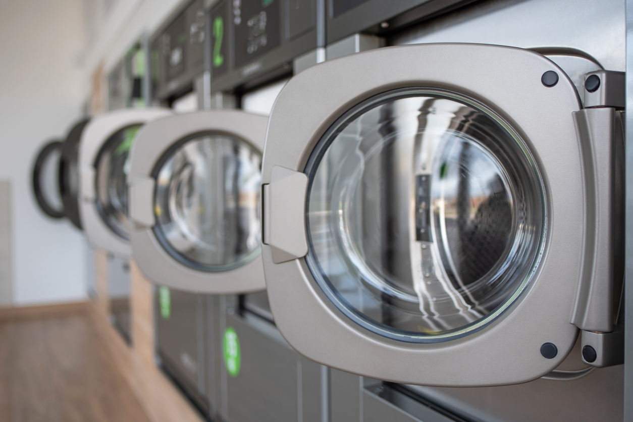 Image of laundry machines in lined up in a row.