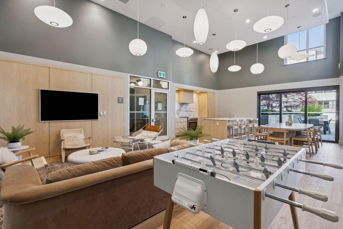 Victor_AmenityLounge-2 Social lounge with very high ceiling, modern lighting, comfortable seating, entertainment, and dining space