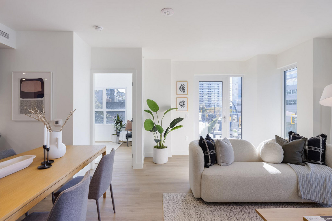 Victor_Dining_Living Sunshine pouring through windows into elegant and comfortably furnished apartment living area