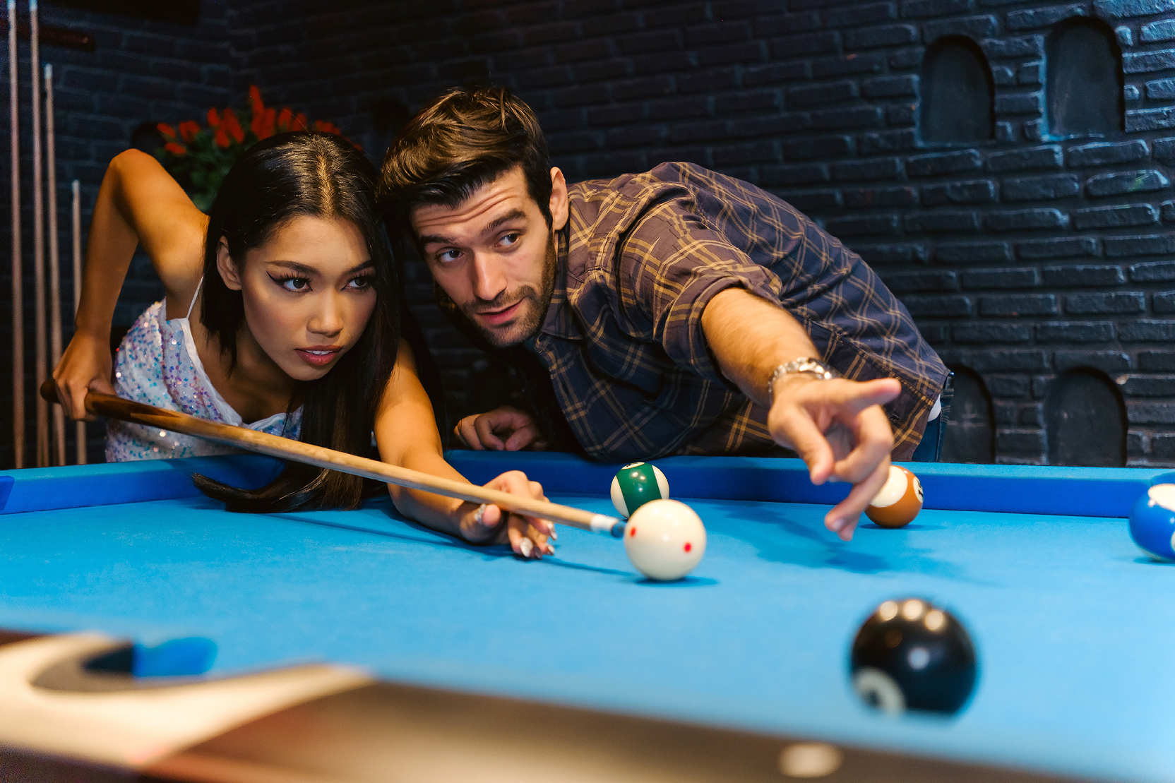 Two people playing pool