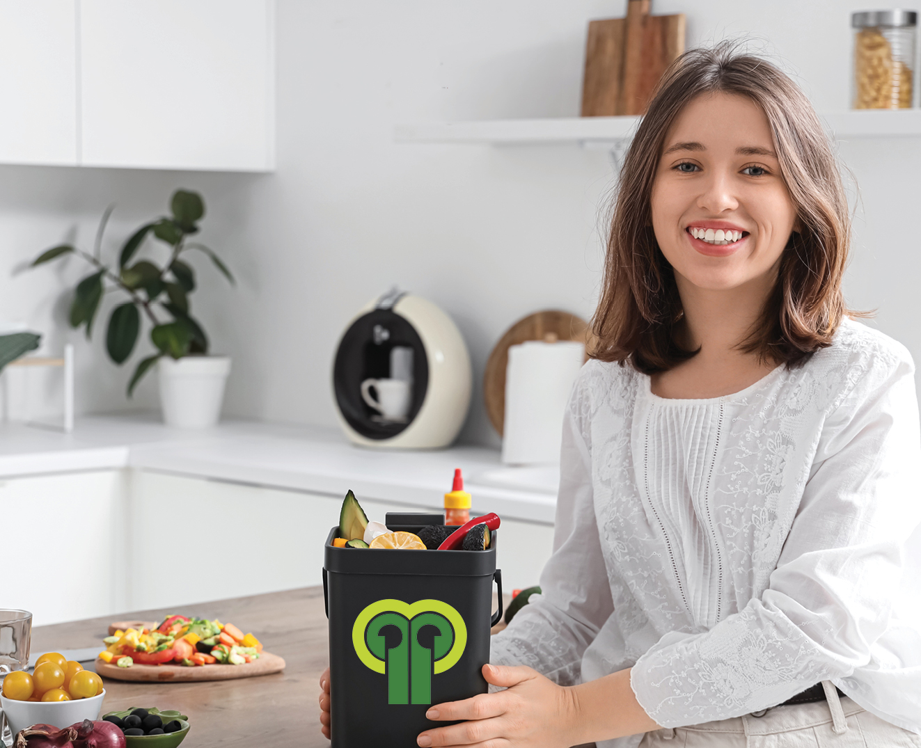 A smiling woman in a bright, modern kitchen.