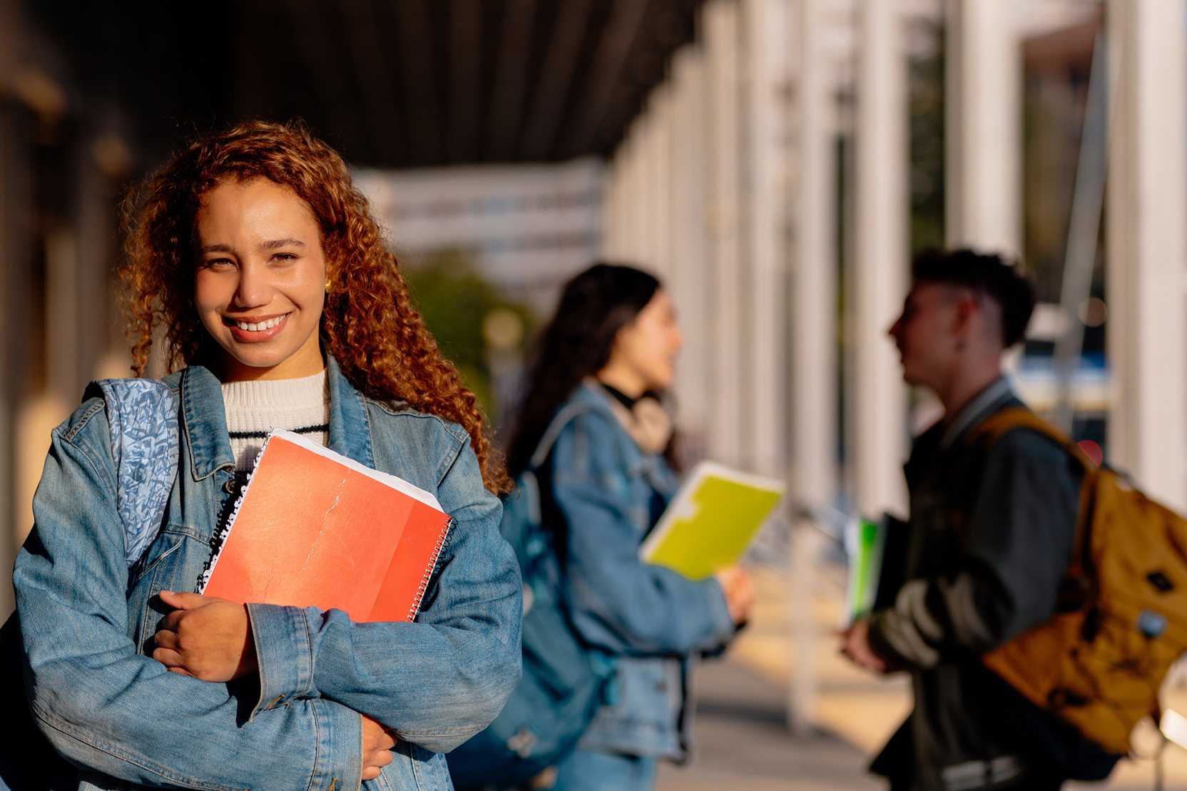A person holding books and smiling
