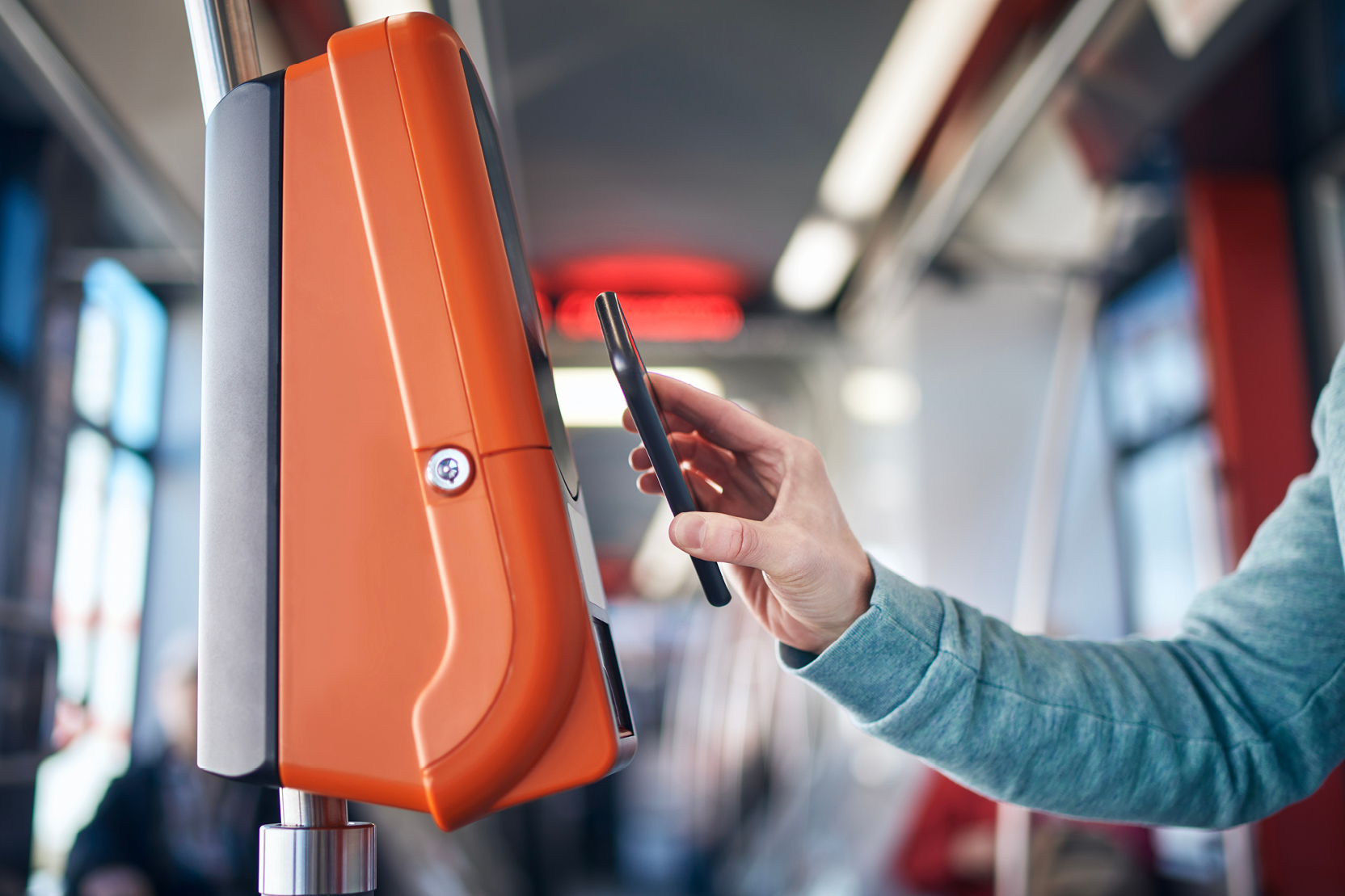 Using a smartphone to tap and pay at transit fare payment terminal