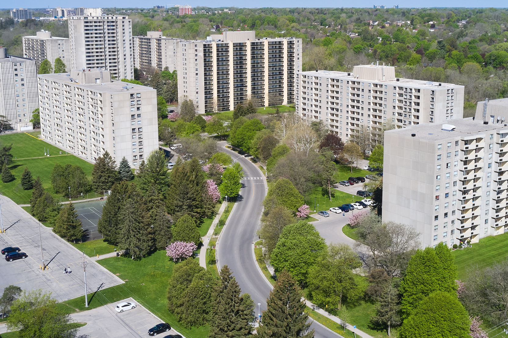 Aerial view of Cherryhill Village with high-rise apartment buildings and green spaces.