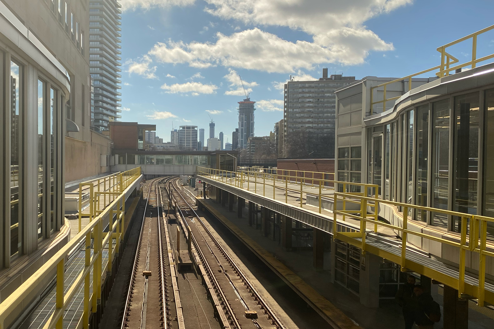 Urban subway tracks with a city skyline in the distance