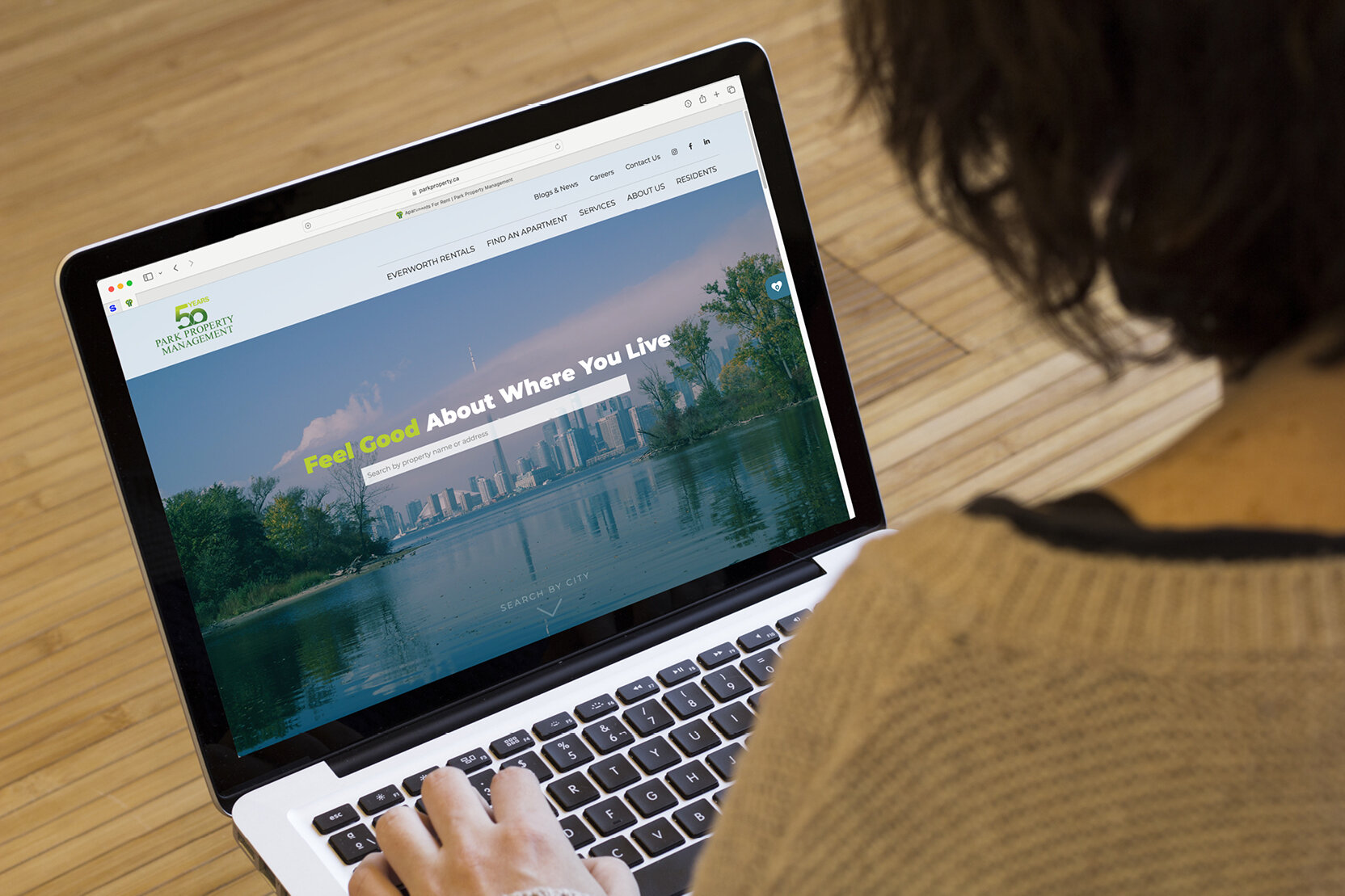 Person browsing Park Property Management's website on a laptop
